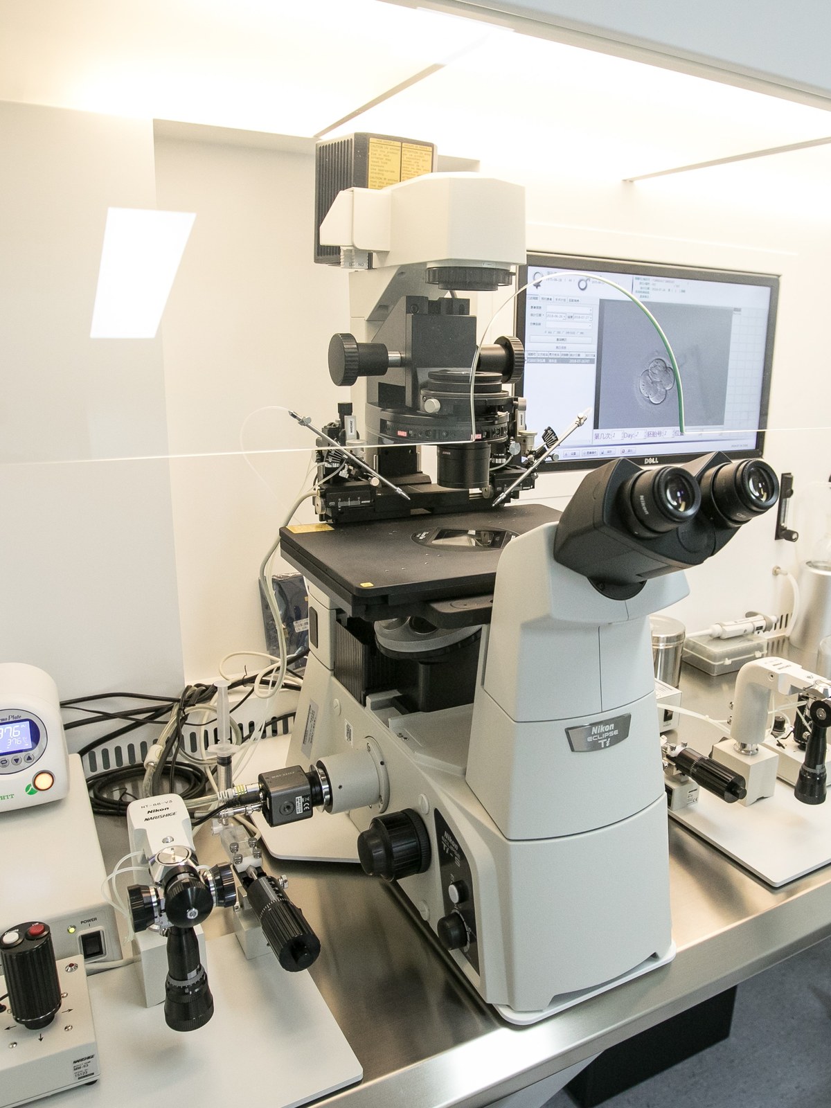 An embryology laboratory micromanipulation workstation with an inverted microscope used for assisted reproduction procedures